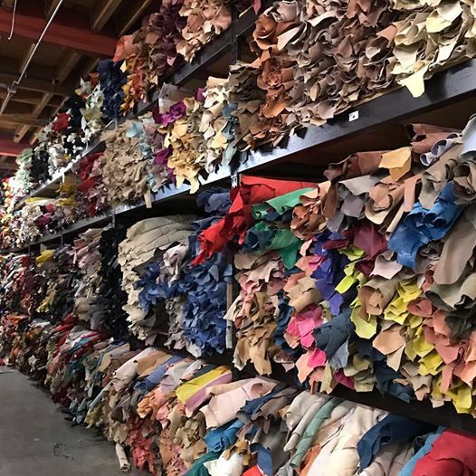 Walls of colorful cowhides stacked in the warehouse
