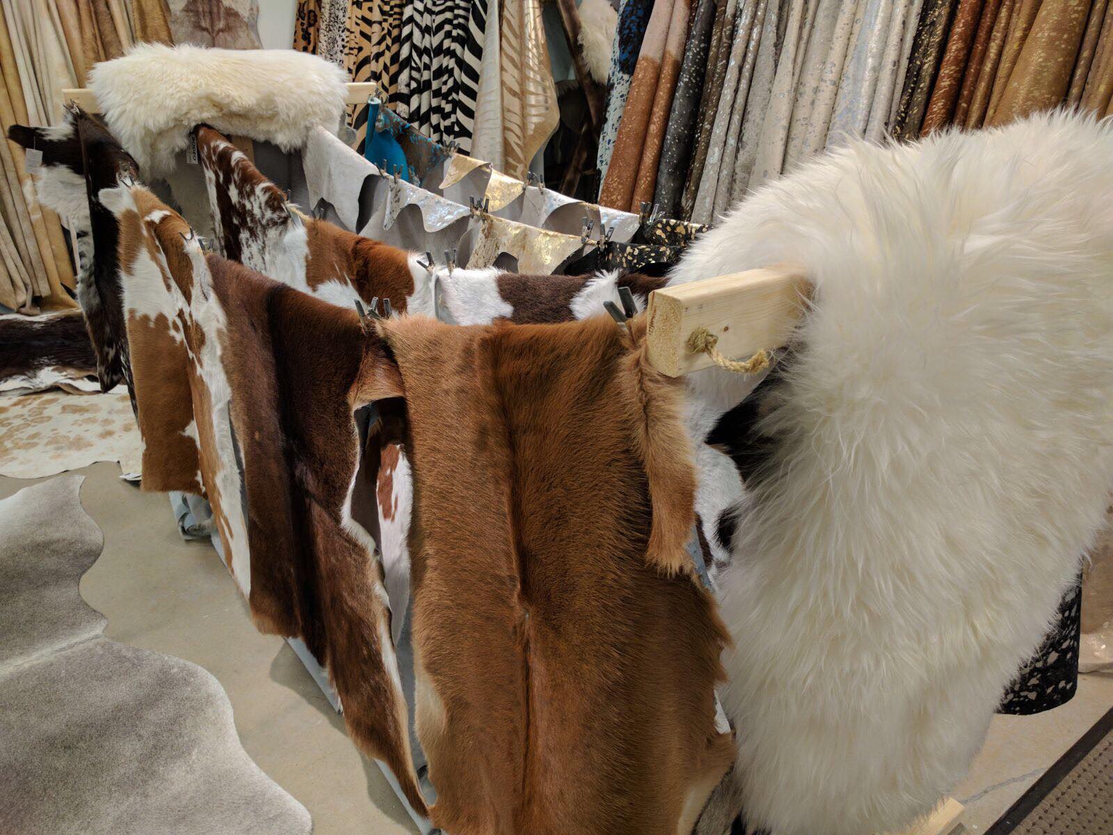 Cowhides, sheepskins and metallic leather hides on display in the Mr. Cowhides showroom